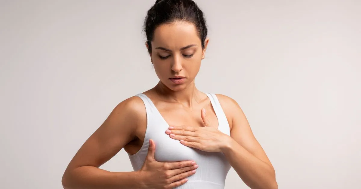 carefully administering a PRP breast lift injection to the décolleté for natural breast enhancement